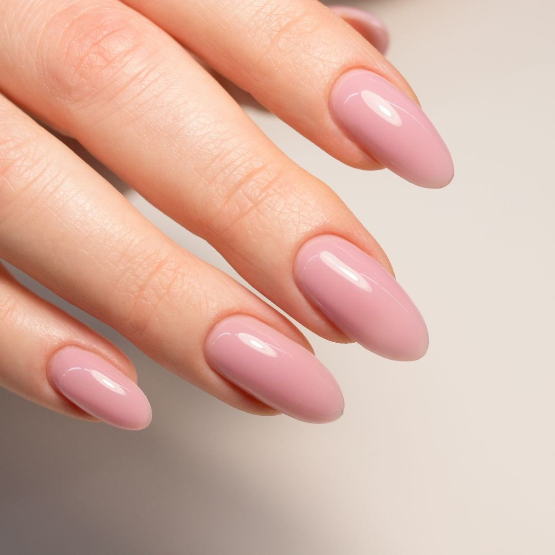 Glossy pink gel manicure on almond nails at Tempt(d) Studio