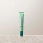 Green lip balm tube on a light beige background